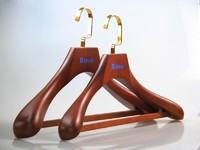 Brown wooden suits hanger with trouser bar